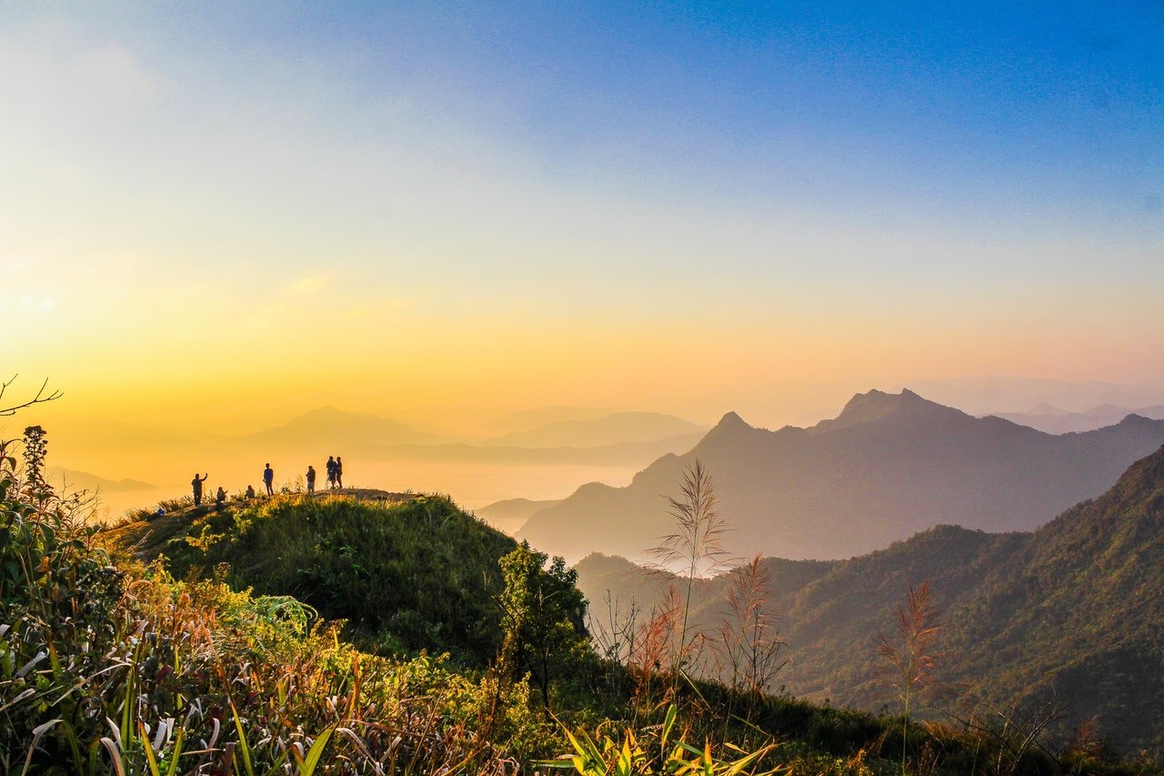 people standing on mountain