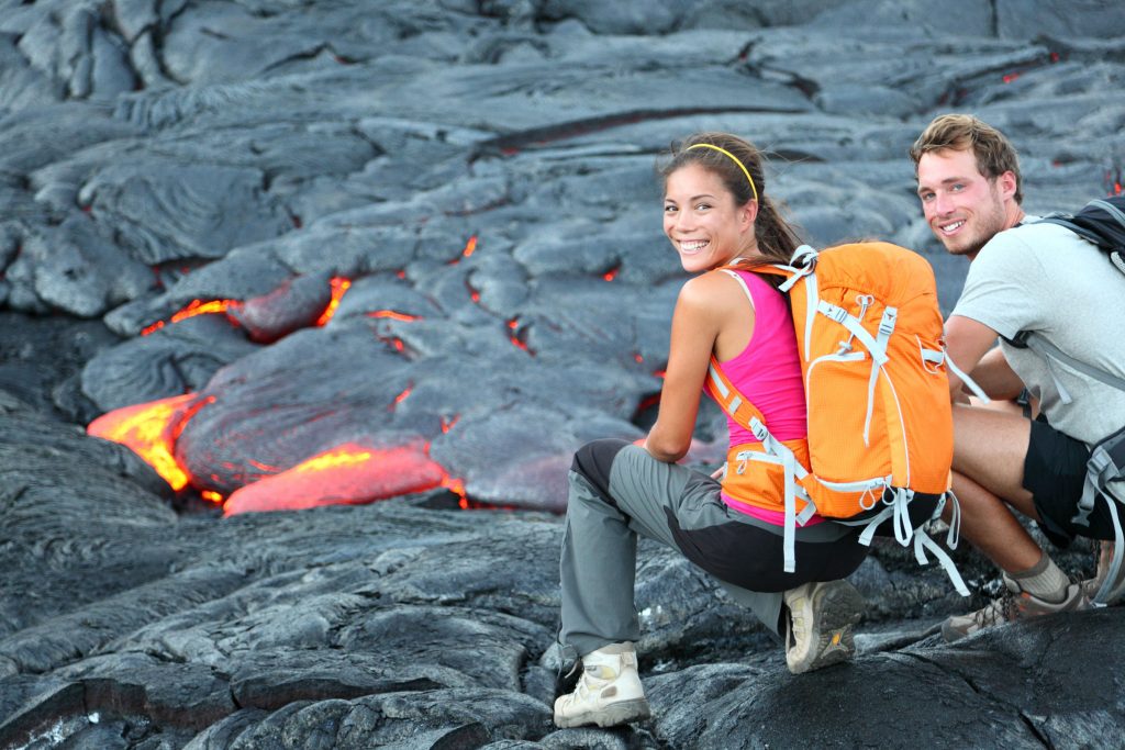 couple looking a lava in Hawaii