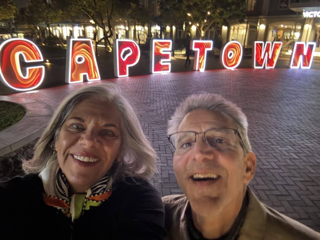 Evening stroll in front of the Cape Town sign, capturing the urban elegance of luxury travel in Cape Town